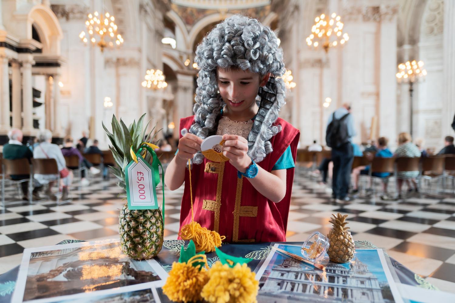 child dressed as Christopher Wren doing craft activities