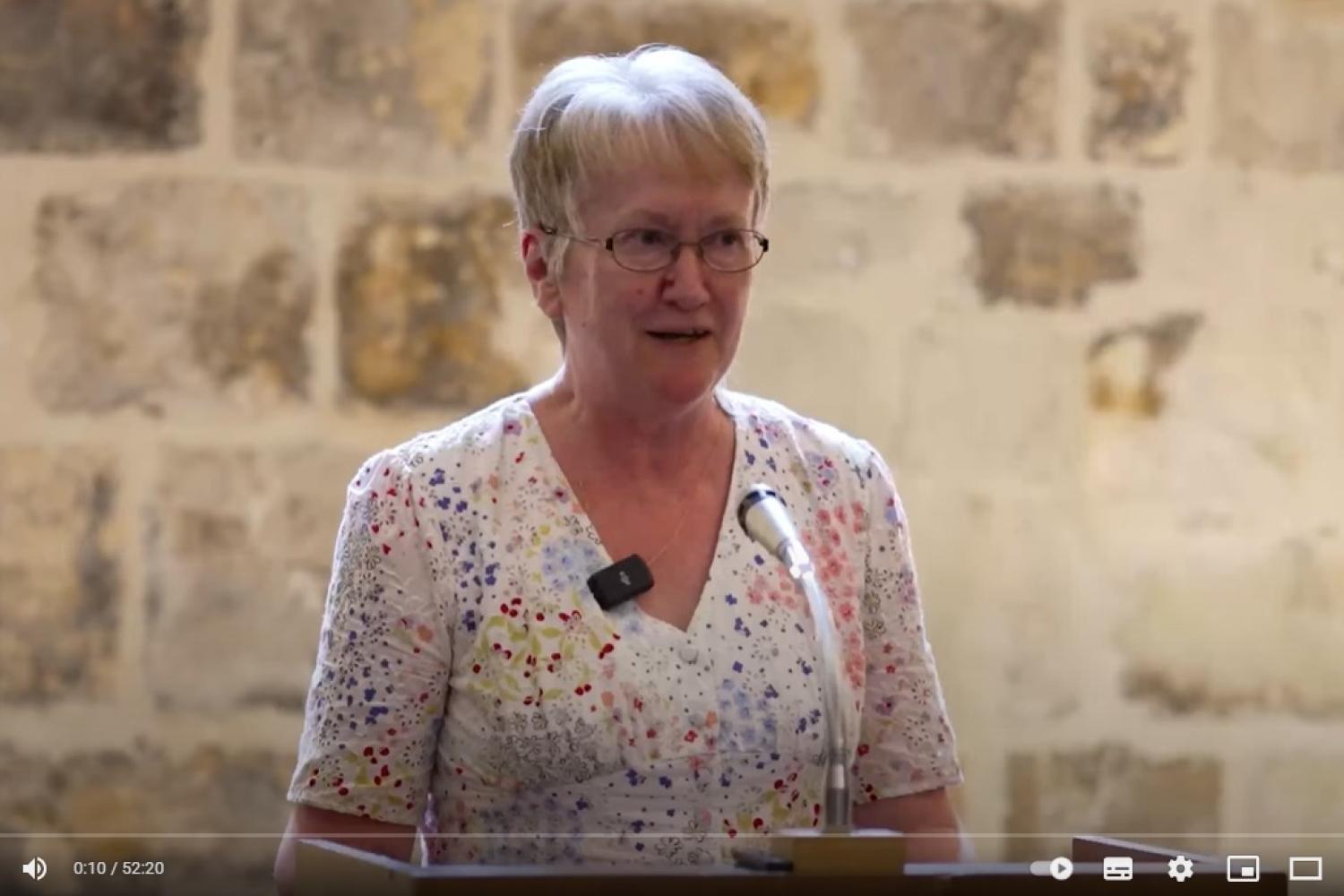 Helen stands at the lectern in the Wren Suite at St Paul's