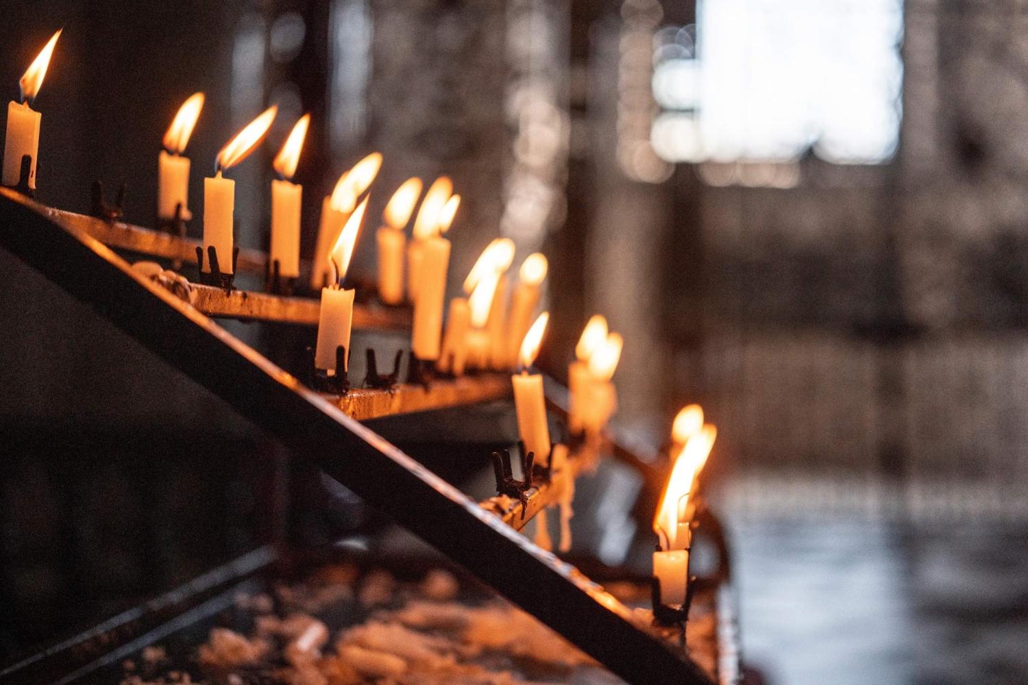 A wrought iron stand of lit candles inside St Paul's Cathedral