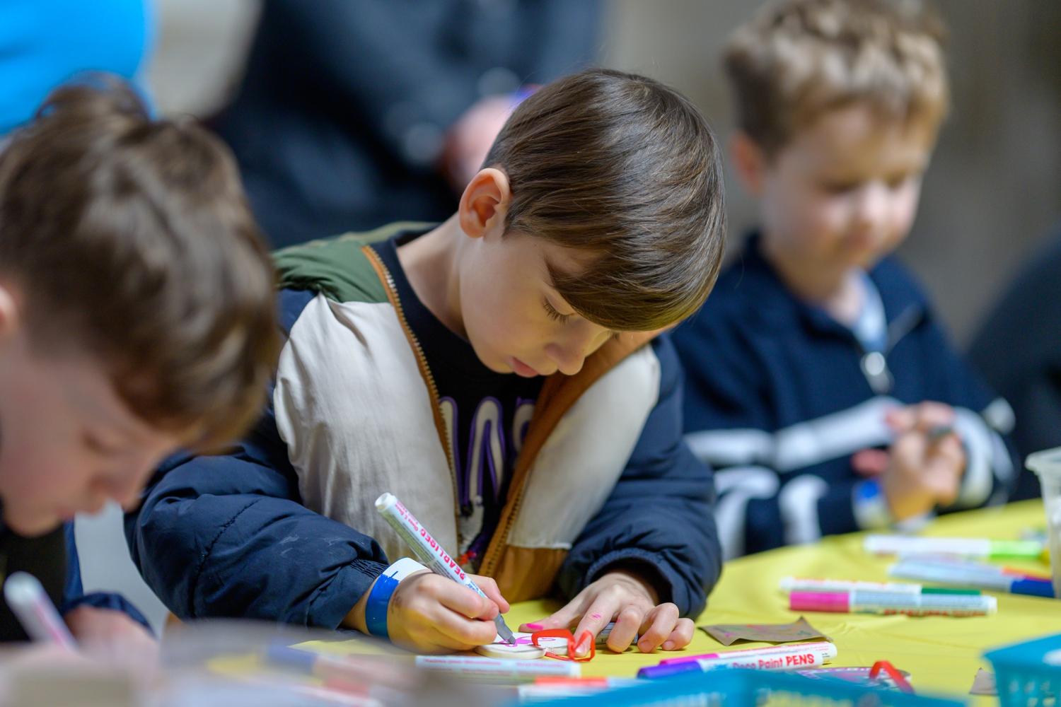 Three children colouring in 