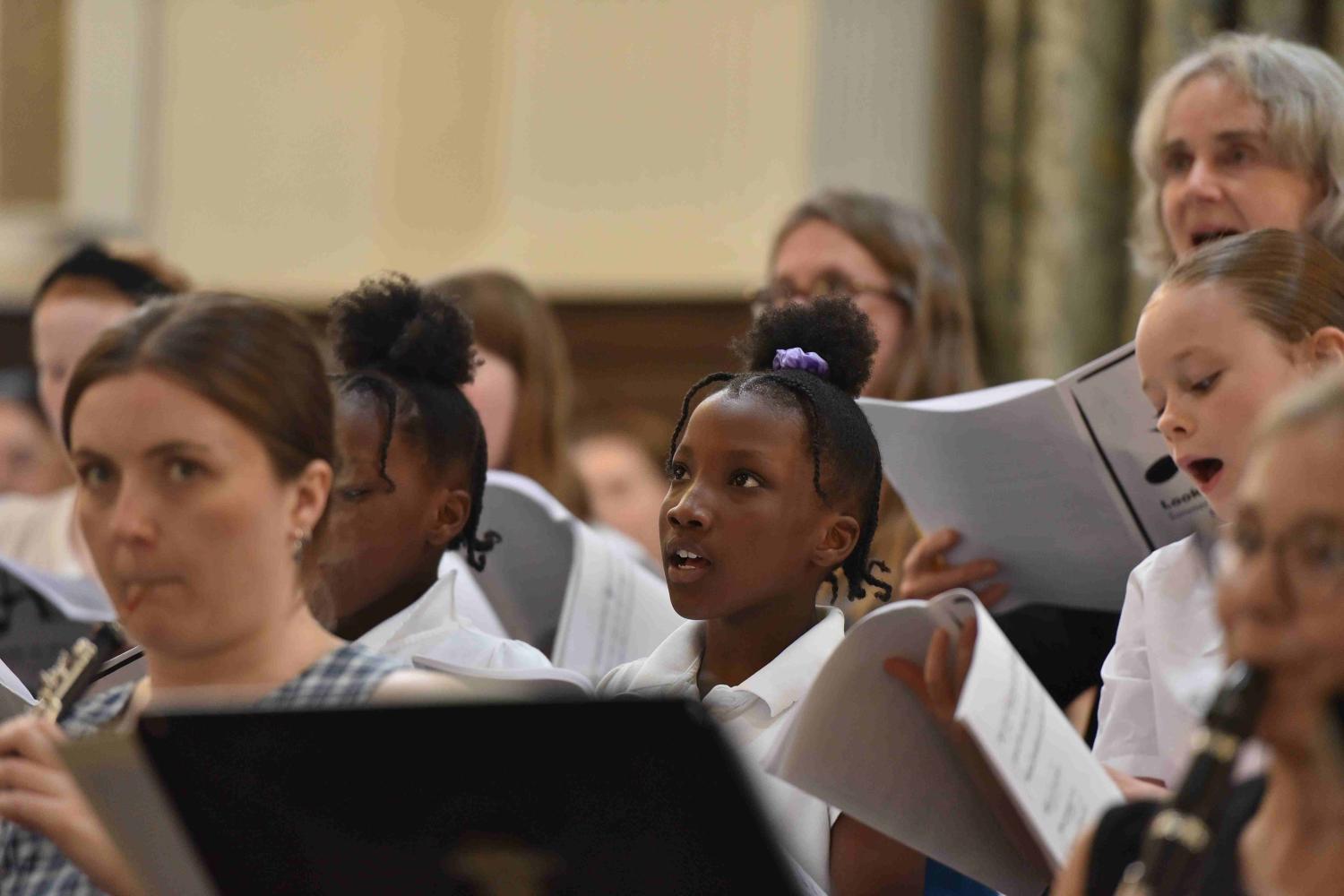 Children and musicians perform at a concert