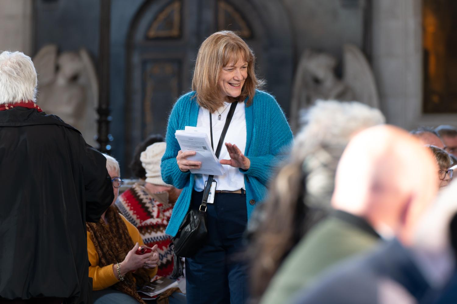 Sarah Holman, a volunteer with the St Paul's Cathedral Institute, speaks to visitors at an event.
