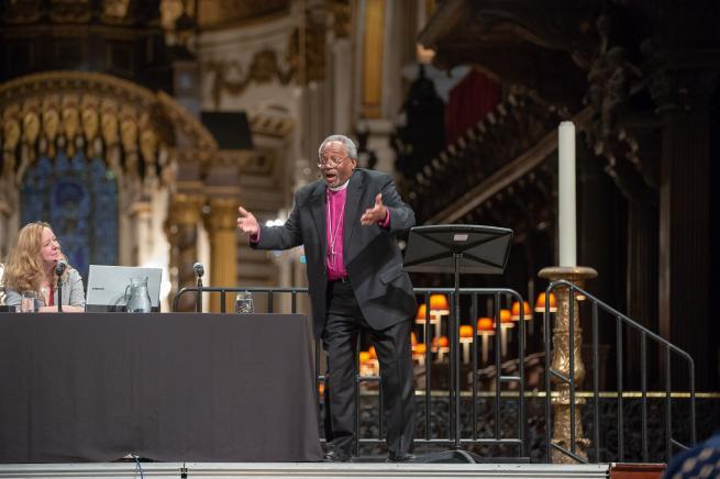 Michael Curry speaks as Paula Gooder smiles alongside at St Paul's Cathedral