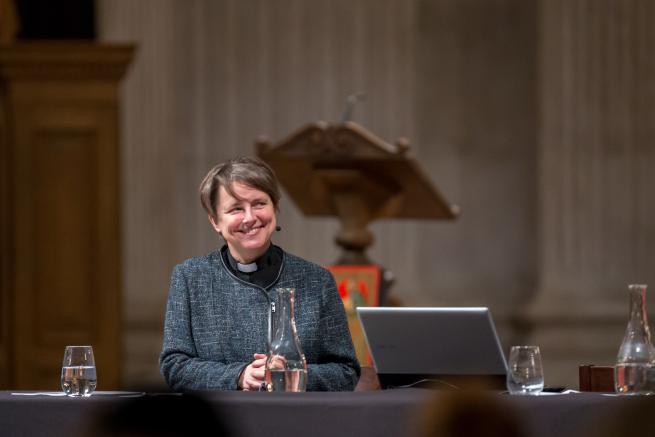 Lucy Winkett smiling on stage at an Adult Learning event in St Paul's Cathedral