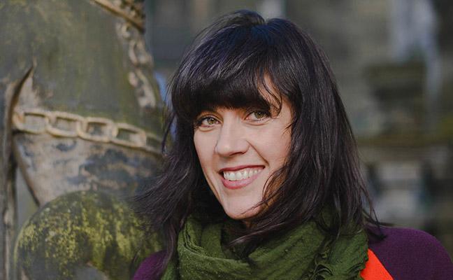 Deborah Lewer outside wearing a green scarf