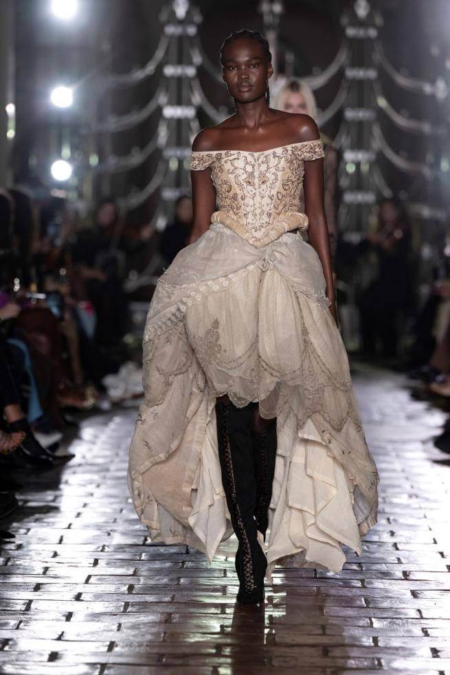 A model walks in a cat walk show in the Crypt