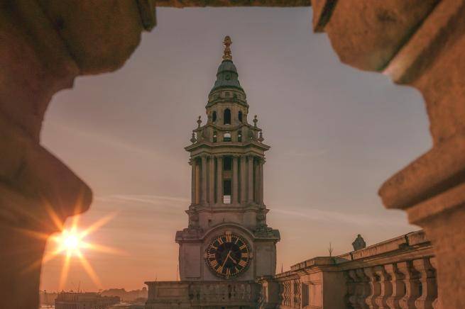 The clock tower seen from the roof looking towards the west, at sunset with the glow of the setting sun to the side