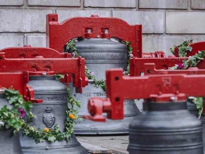 The bells, decorated with flower garlands and with newly painted red yokes, sit outside the cathedral to be blessed before being re-hung after refurbishment.