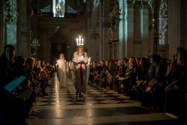 A candlelit procession for the Sankta Lucia service.
