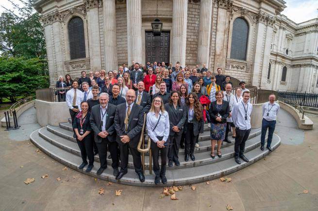 A group of St Paul's Cathedral staff gathered on the steps of the Cathedral.