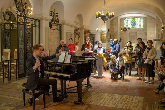 A group singing with a pianist