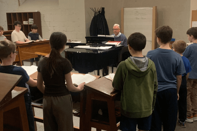 Choir practice around the piano.