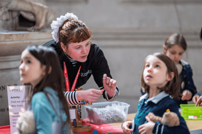 Emily, a member of the Learning team, speaks to children at Messy Cathedral.