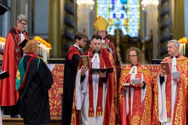 The Revd Timothy Miller stands at the altar during his installation.