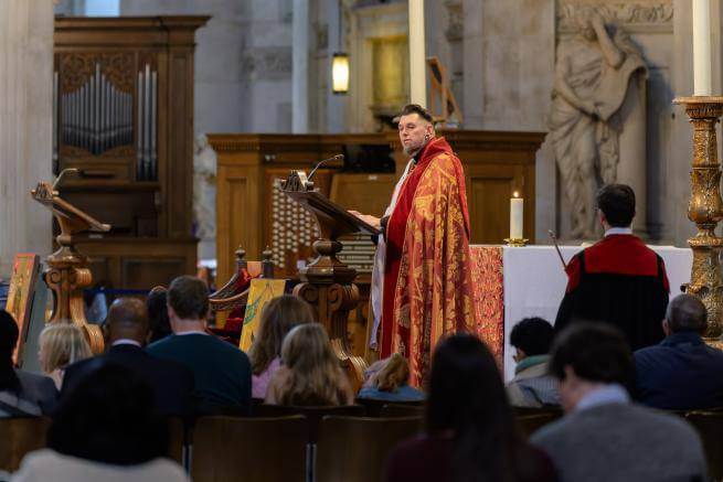 The Revd Timothy Miller speaks from a lectern.