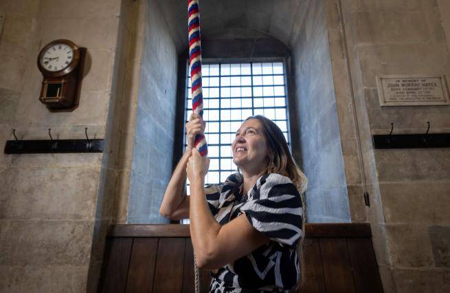 A bereaved mother rings a bell at St Paul's Cathedral in memory of her late daughter