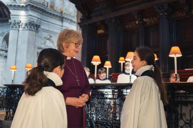 Bishop Sarah, Bishop of London, speaking to two choristers