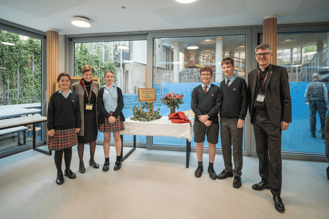Four choristers stand with the Dean and the Head of St Paul's Cathedral School at the opening of the new girls' boarding house.
