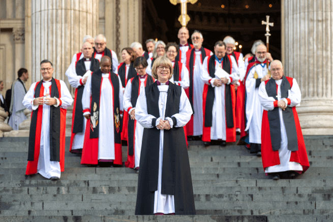 Archbishop Sarah stands in front of a group of bishops.