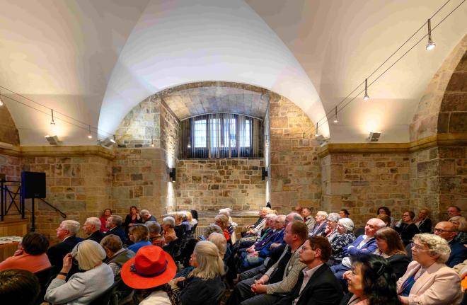 Volunteers sit in the Wren Suite for a meeting.