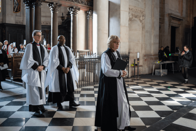 Archbishop Sarah processes through the West End followed by two bishops.