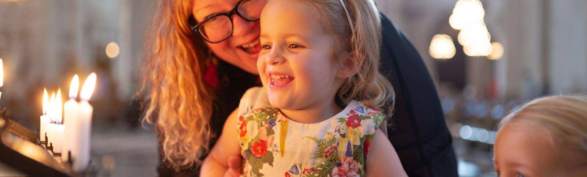 family children mother candles prayer smiling