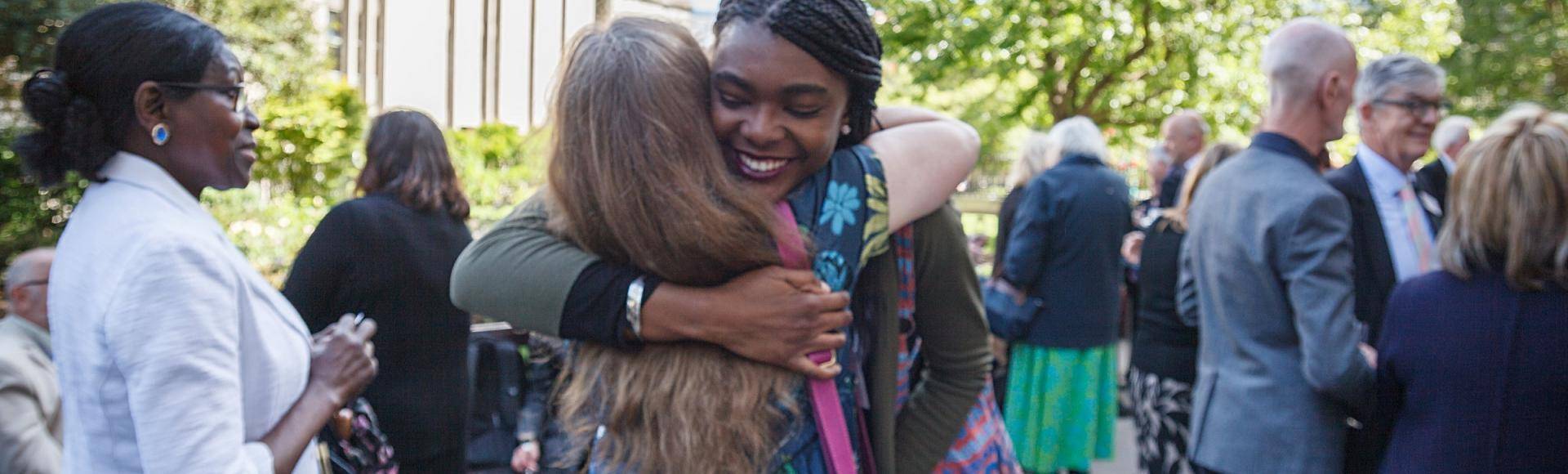 volunteer freinds hug sun churchyard