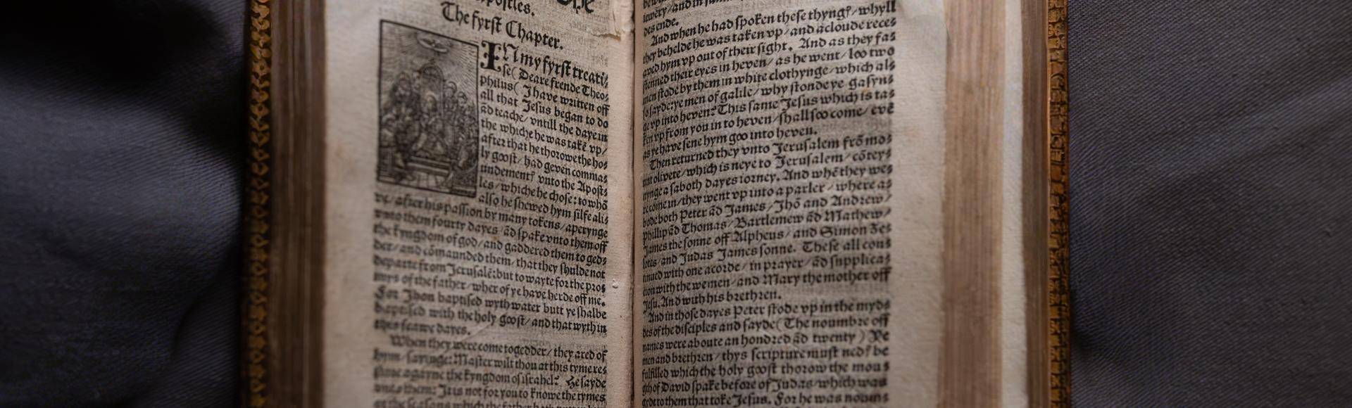 William Tyndales's new testament bible open on the first page of Acts of the Apostles