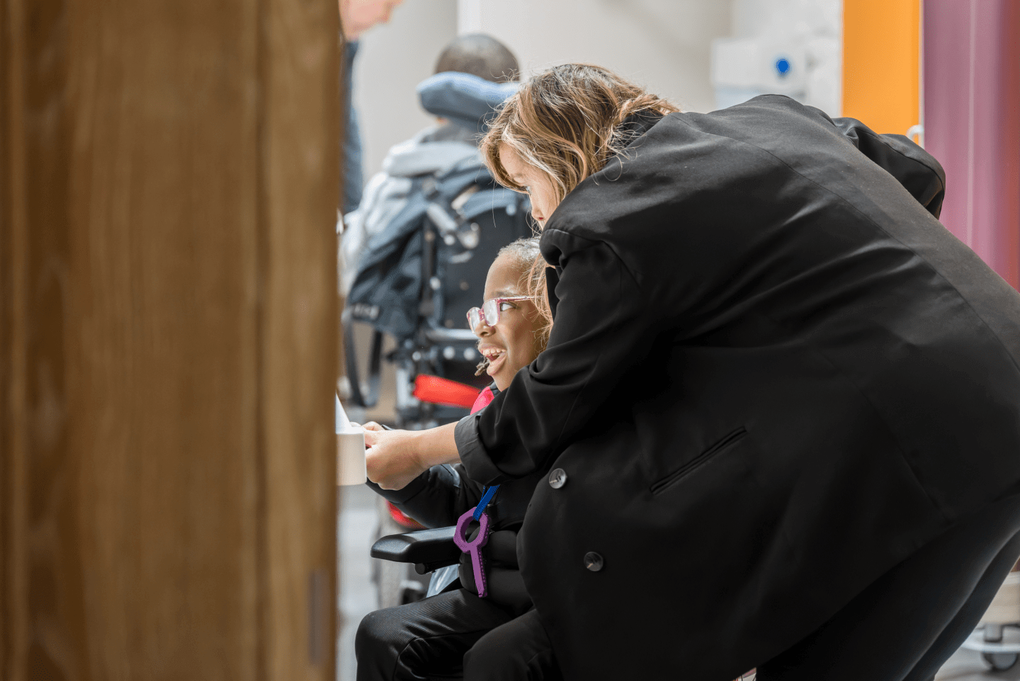 An adult woman and a child using the sink in the new Changing Places toilet