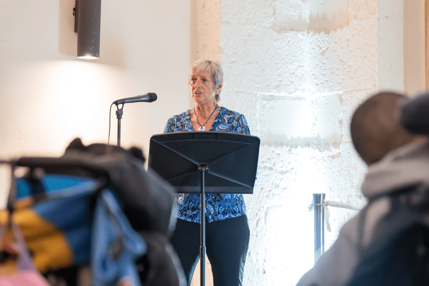 People listening to a female speaker at the Changing Places opening celebration