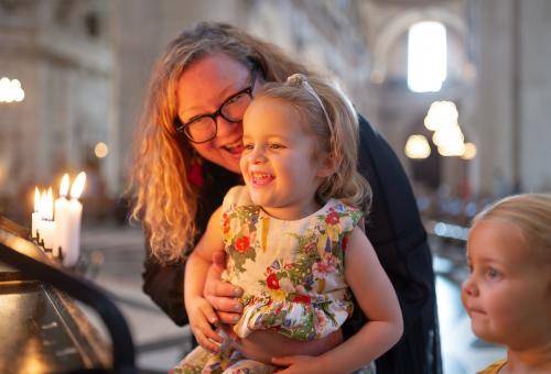 family children mother candles prayer smiling