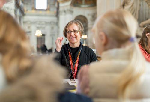children being greeted by member of staff