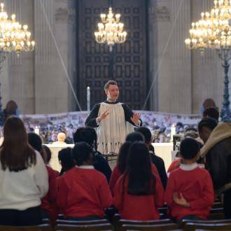 Conductor leading choir of children