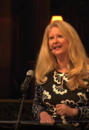 Helen Bond is a white woman with long blond hair and is talking in St Paul's Cathedral