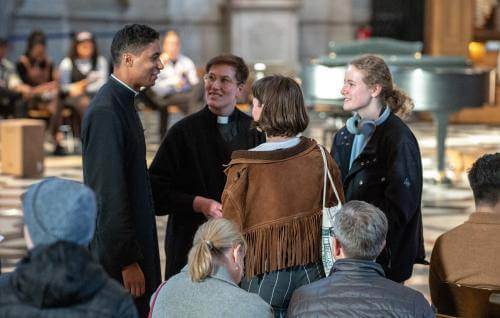 clergy priest talking to worshippers