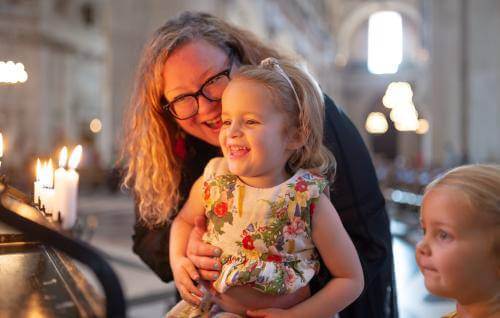 family children mother candles prayer smiling