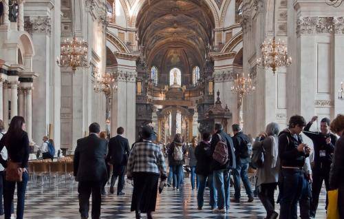 visitors sightseeing walking up nave