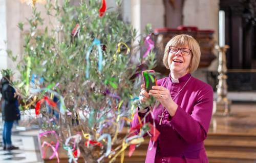 bishop sarah mullally smiling with tree at messy cathedral event