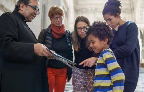 family looking at a map inside cathedral 