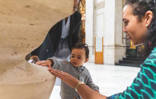 little boy touching cathedral stone