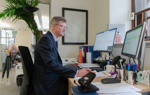 member of staff working at desk 