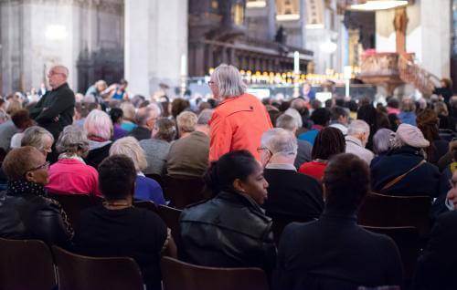 Audience members take their seats at an event at the cathedral