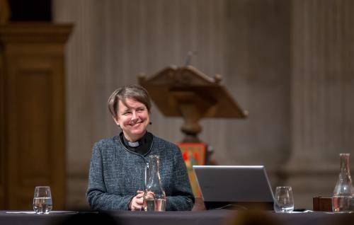 Lucy Winkett smiling on stage at an Adult Learning event in St Paul's Cathedral