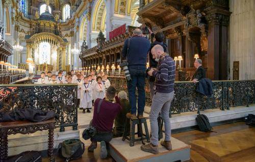 Press photographers take photos of the choristers during a media visit