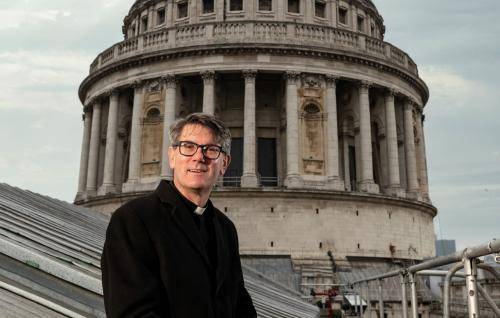 Dean of St Paul's, Andrew Tremlett sits in front of the Dome of the Cathedral