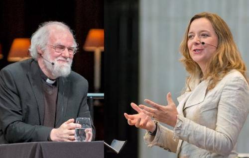 Rowan Williams sitting on stage with the lamps of the quire in the background alongside a picture of Paula Gooder, hands palm upwards in front of her, standing with a pillar and a corner of a wooden lectern in the background.