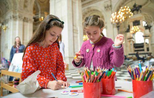 Two young children making badges inside St Paul's Cathedral
