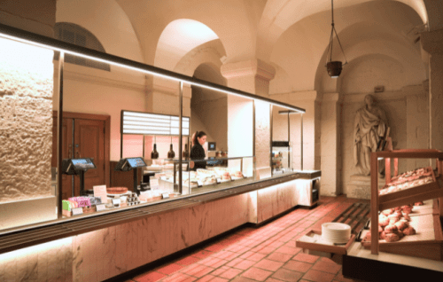 A wide shot of the new Crypt Cafe, with arched ceilings and a long countertop.