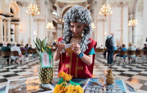 child dressed as Christopher Wren doing craft activities