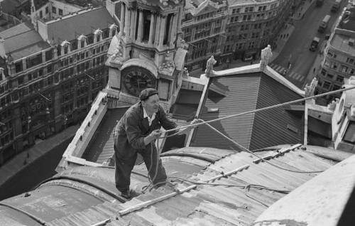 Harry Sharr, a member of the St Paul's Watch, tugs on a rope on top of the roof of St Paul's.